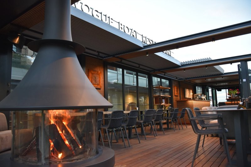 The pergola terrace with a wood-burning fireplace
